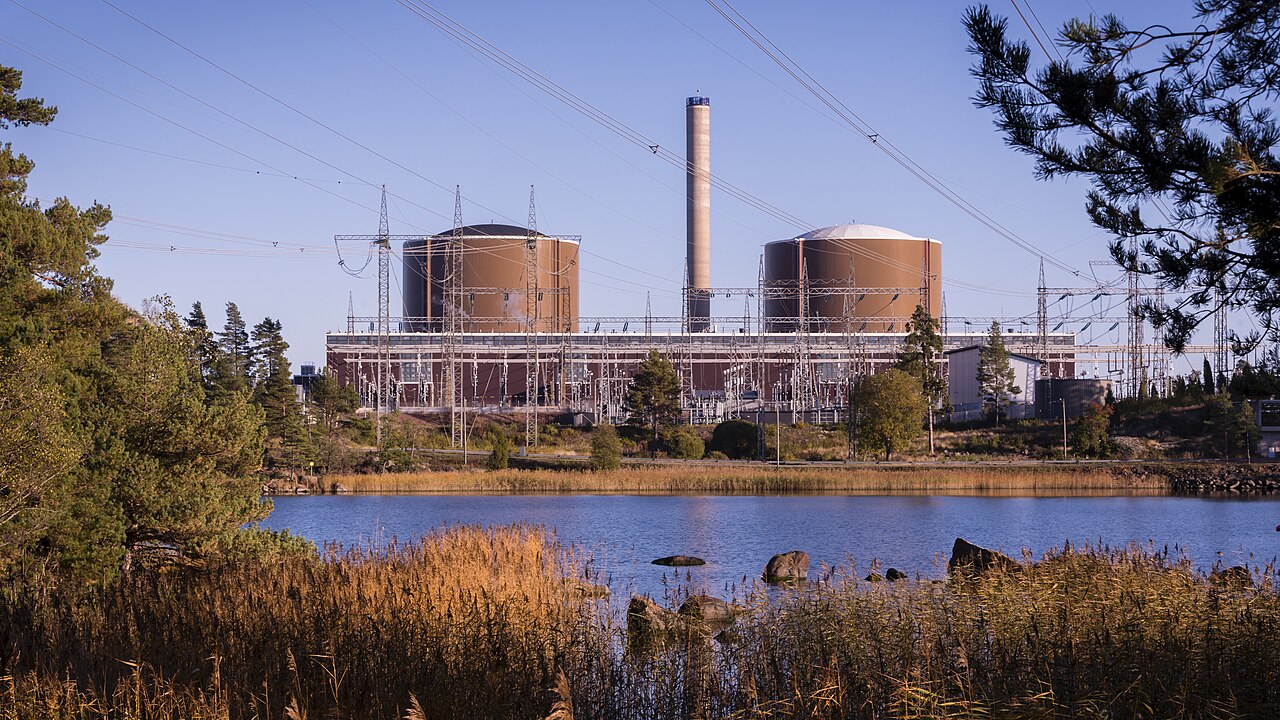 Fortum Loviisa nuclear power plant on the Gulf of Finland — twin reactor domes, stack, and switchyard